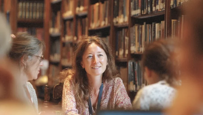 Consultant in library speaking with parents