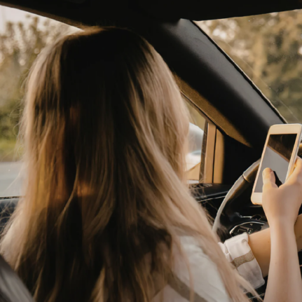 Woman using phone while driving