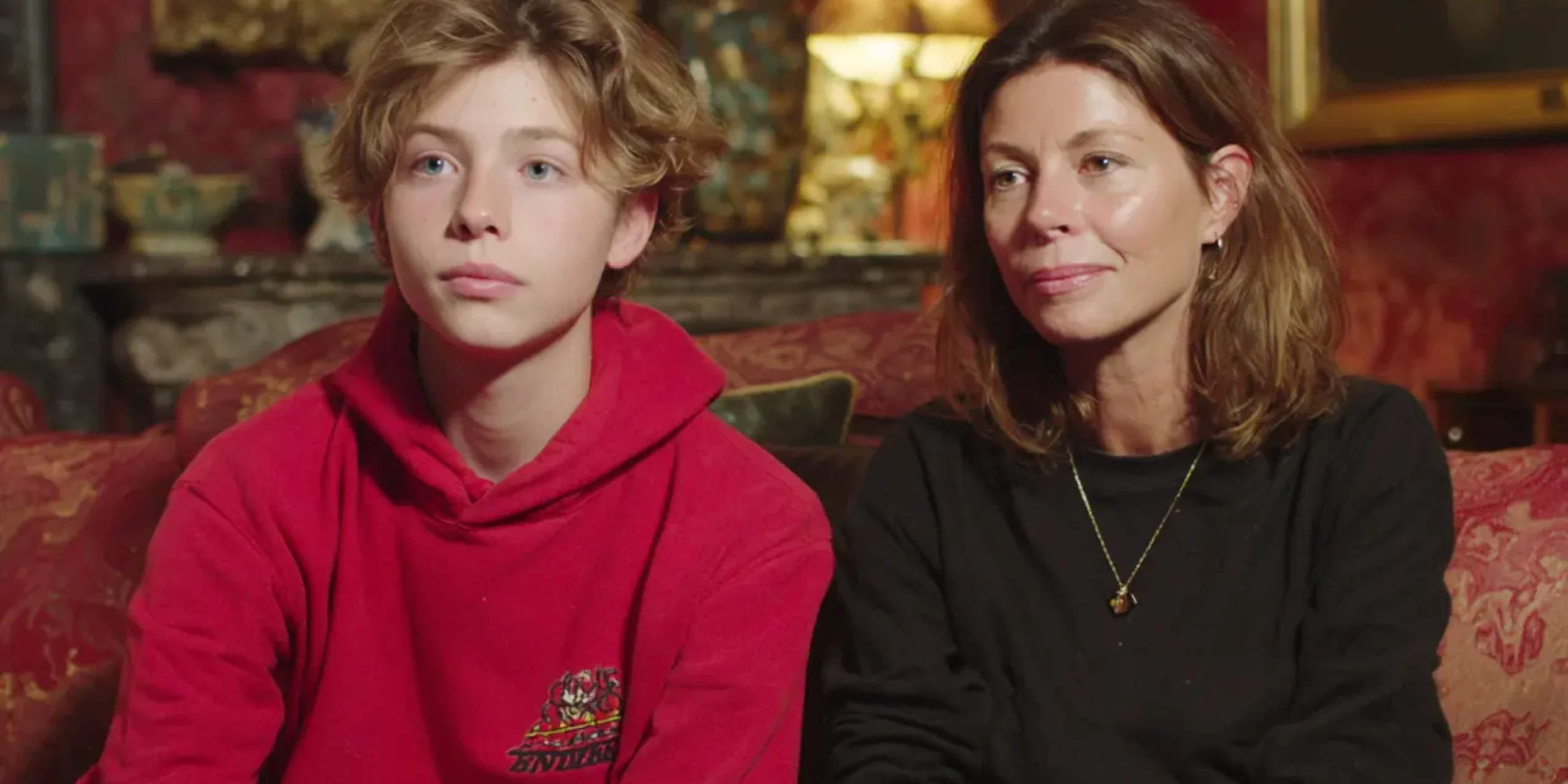 Mother and son giving testimonial on a sofa at home in chelsea